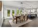 Open concept dining area featuring hardwood floors, modern lighting and convenient access to the kitchen at 490 Third Ave, Scottdale, GA 30079