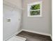 Functional laundry room with a utility sink, shelving, and a bright window offering natural light at 490 Third Ave, Scottdale, GA 30079