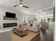 Spacious living room with modern lighting, fireplace, and open layout to the dining area at 490 Third Ave, Scottdale, GA 30079