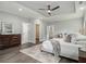 Well-lit main bedroom featuring dark wood floors, tray ceiling, and an expansive layout at 490 Third Ave, Scottdale, GA 30079