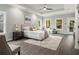 Bright and open main bedroom with a tray ceiling and lots of natural light from multiple windows at 490 Third Ave, Scottdale, GA 30079