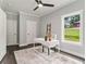 Home office with a sleek white desk, a comfortable chair, and natural light from the window at 490 Third Ave, Scottdale, GA 30079