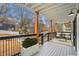 Relaxing outdoor porch with seating, potted plants, and black metal railing at 490 Third Ave, Scottdale, GA 30079