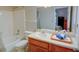 Clean bathroom featuring a shower-tub combo, vanity with cabinet and a mirror at 1005 Berkeley Woods Dr, Duluth, GA 30096