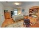 Comfortable bedroom with wood floors, dresser, and bright natural light at 1005 Berkeley Woods Dr, Duluth, GA 30096