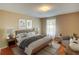 Well-lit staged bedroom with hardwood floors and furniture at 1005 Berkeley Woods Dr, Duluth, GA 30096