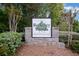 A stone Berkeley Woods Condominiums sign is surrounded by lush trees and landscaping at 1005 Berkeley Woods Dr, Duluth, GA 30096