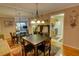 Inviting dining room with hardwood floors and stylish light fixture, adjacent to kitchen at 1005 Berkeley Woods Dr, Duluth, GA 30096