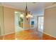 Bright dining room with hardwood floors and view to the living room and kitchen at 1005 Berkeley Woods Dr, Duluth, GA 30096