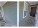 Close-up of entrance with gray painted wood and white trim details at 1005 Berkeley Woods Dr, Duluth, GA 30096