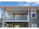 Charming exterior view showcasing balcony with white railing and green siding at 1005 Berkeley Woods Dr, Duluth, GA 30096