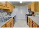 Efficient kitchen featuring stainless steel appliances, wood cabinets and mosaic backsplash at 1005 Berkeley Woods Dr, Duluth, GA 30096