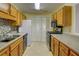 Well-lit kitchen with wood cabinets, modern appliances, and a stylish backsplash at 1005 Berkeley Woods Dr, Duluth, GA 30096