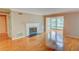 Living room boasting gleaming hardwood floors, fireplace, and bright windows at 1005 Berkeley Woods Dr, Duluth, GA 30096