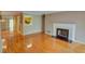 Bright living room featuring hardwood floors, a fireplace, and a view to the kitchen at 1005 Berkeley Woods Dr, Duluth, GA 30096