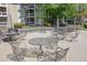 Community patio with tables, chairs, and lush landscaping for outdoor enjoyment at 1005 Berkeley Woods Dr, Duluth, GA 30096