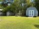 Spacious backyard featuring a storage shed and lush green lawn, perfect for outdoor activities at 1109 Granite Ln, Loganville, GA 30052