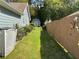 Well-maintained backyard with a fenced-in lawn and storage shed in the distance at 1109 Granite Ln, Loganville, GA 30052