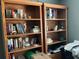 Pair of wooden bookcases filled with an array of books, vases, and decorative items at 1109 Granite Ln, Loganville, GA 30052