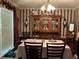 Elegant dining room with vintage-inspired decor and a large hutch for displaying fine china and decor at 1109 Granite Ln, Loganville, GA 30052