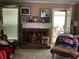 Inviting living room featuring a brick fireplace, creating a warm and comforting space for relaxation and gatherings at 1109 Granite Ln, Loganville, GA 30052