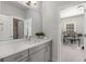 Bright bathroom with a large vanity, sink, and mirror; bedroom viewable from doorway at 1157 Hannaford Ln, Johns Creek, GA 30097