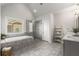 Elegant bathroom featuring a soaking tub, glass enclosed shower, and double vanity, and neutral colors at 1157 Hannaford Ln, Johns Creek, GA 30097