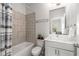 Full bathroom features a shower-tub combo, neutral tile, and a vanity with countertop space at 1157 Hannaford Ln, Johns Creek, GA 30097
