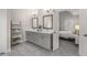 Bathroom featuring double vanities, modern fixtures, and a linen tower in a neutral color palette at 1157 Hannaford Ln, Johns Creek, GA 30097