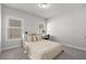 Bright bedroom features a bed, desk, and ample natural light from a large window at 1157 Hannaford Ln, Johns Creek, GA 30097