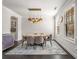 Stylish dining room with a modern chandelier, hardwood floors, and neutral decor at 1157 Hannaford Ln, Johns Creek, GA 30097