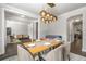 Open-concept dining area with a modern chandelier, seating for six, and easy access to other living spaces at 1157 Hannaford Ln, Johns Creek, GA 30097