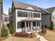 Beautiful two-story home with a covered porch and landscaped garden, showcasing its curb appeal at 1157 Hannaford Ln, Johns Creek, GA 30097