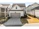 Home's exterior, highlighting the two-car garage, landscaping, and community's architectural style at 1157 Hannaford Ln, Johns Creek, GA 30097