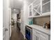 Hallway with a wine fridge and adjacent built-in cabinets provides access to a dining area at 1157 Hannaford Ln, Johns Creek, GA 30097