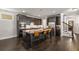 Open kitchen features dark cabinets, stainless appliances, and a large island with seating and stone countertops at 1157 Hannaford Ln, Johns Creek, GA 30097