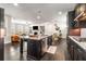 Spacious kitchen featuring an island, stainless steel appliances, and an open layout to the living spaces at 1157 Hannaford Ln, Johns Creek, GA 30097