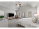 Airy main bedroom with high ceilings, ceiling fan, a sitting chair and light-filled with neutral decor at 1157 Hannaford Ln, Johns Creek, GA 30097
