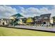 View of the community playground with swings, slides, and covered seating at 1157 Hannaford Ln, Johns Creek, GA 30097