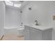 Bright bathroom featuring a shower-tub combination, a toilet, and a gray vanity at 2243 Provence Ne Ct, Marietta, GA 30066