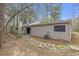 Exterior view of home with stone walkway and lush, surrounding foliage at 2243 Provence Ne Ct, Marietta, GA 30066