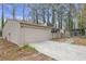 Beige single-Gathering home with an attached garage and a quaint sunroom nestled amongst mature trees at 2243 Provence Ne Ct, Marietta, GA 30066