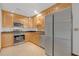 Modern kitchen features stainless steel appliances, wood cabinets, and granite countertops at 2243 Provence Ne Ct, Marietta, GA 30066