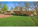 Brick home showcasing a spacious green backyard, deck, and covered porch perfect for outdoor living and entertaining at 681 Counsel Dr, Marietta, GA 30068