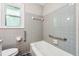 Bathroom features a toilet, white tub, and gray tiled walls at 681 Counsel Dr, Marietta, GA 30068