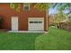 A bright white garage door nestled in a lush green lawn, connecting convenience with outdoor beauty at 681 Counsel Dr, Marietta, GA 30068