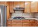 Modern kitchen featuring granite countertops, gas range and stainless hood at 681 Counsel Dr, Marietta, GA 30068