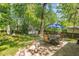 Inviting backyard with a stone patio, dining set, lounge chairs, and lush green landscaping at 1123 Seaboard Nw Ave, Atlanta, GA 30318