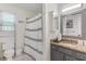 Bright bathroom featuring a granite countertop, white sink, decorative mirror, toilet, and shower with a curtain at 1123 Seaboard Nw Ave, Atlanta, GA 30318