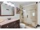 Elegant bathroom with a granite countertop vanity and a tiled shower with a glass door at 1123 Seaboard Nw Ave, Atlanta, GA 30318